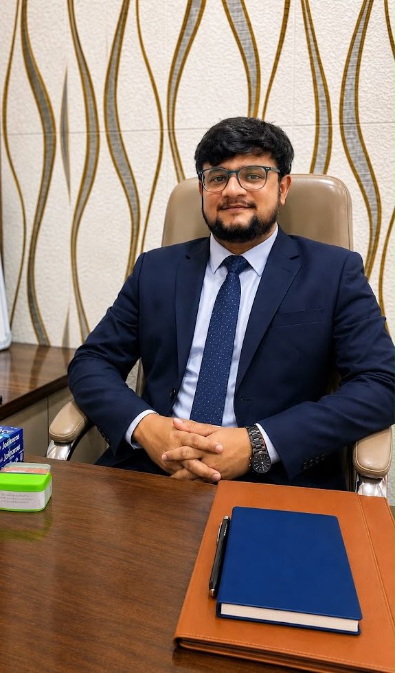 Dr. Adarsh D. Patil seated at the consulting desk in his clinic