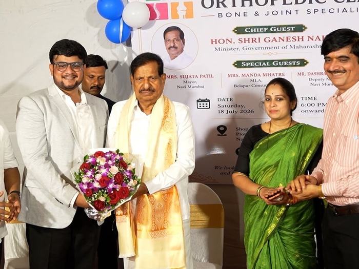 Dr. Adarsh Patil presenting a bouquet of flowers to the chief guest, who has been given a ceremonial shawl