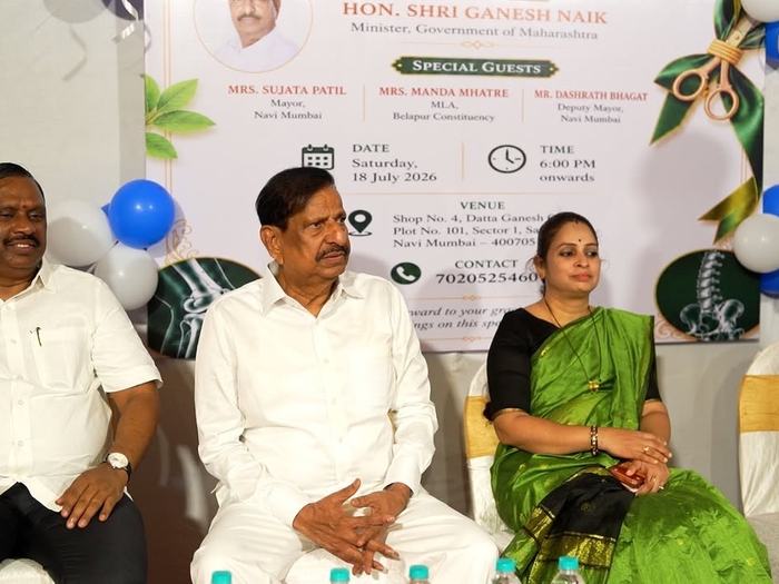 Invited guests seated together in front of the event banner during the ceremony